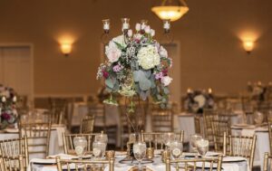 Wedding centerpiece with flowers and eucalyptus with candles